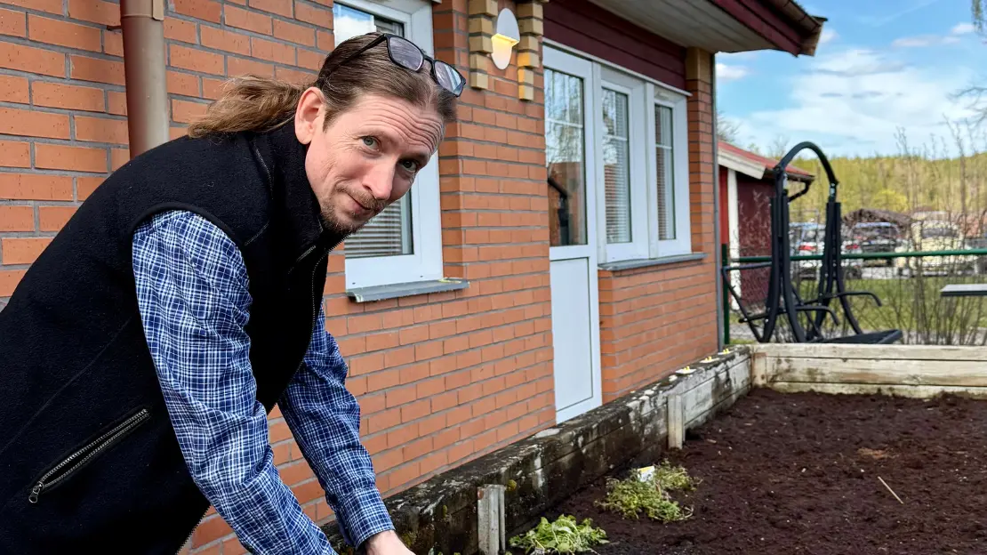 Ulrik ser glad ut med händerna i pallkragen utanför ett boendehus.